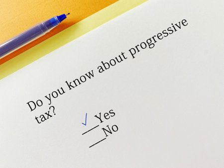 A person is answering question about taxation. He knows about progressive tax.の写真素材