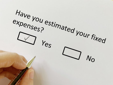 A person is answering question about finance. He has estimated his fixed expenses.の写真素材