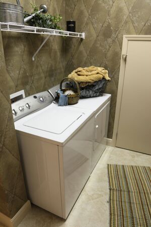 New, modern laundry room with shelf and appliancesの写真素材