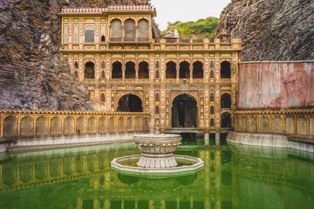 Monkey temple (galtaji) with pilgrims bathe in Jaipur, India.の写真素材