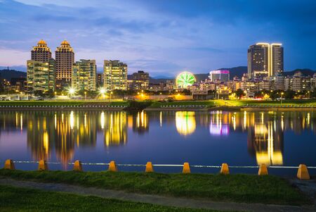 Skyline of Taipei by the river at night in taiwanの写真素材