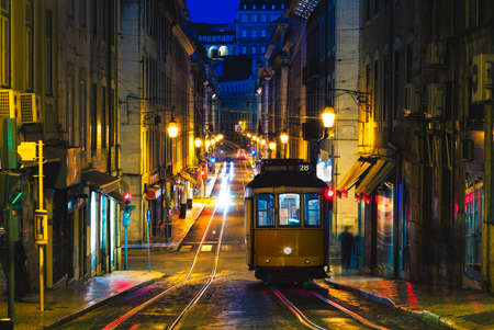 vintage carrier on tram line 28 in lisbon, portugal at nightのeditorial素材