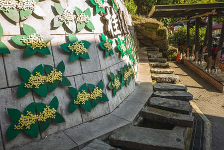Old stone channel used for laundry at the entrance of Osmanthus Alley in nanzhuang, taiwan. Translation: Osmanthus Alleyの写真素材