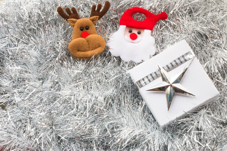 Santa claus, Christmas gift box and decoration on silver fir twigs backgroundの写真素材