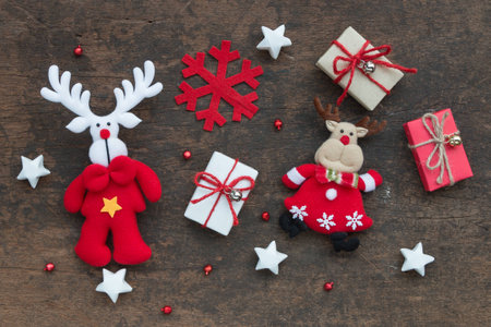 Christmas gift box and decoration on wood background, flat laying in top viewの写真素材