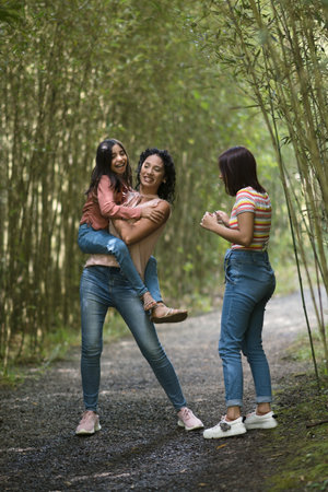 Beatiful mother and daughters enjoying a vacation day in the parkの写真素材