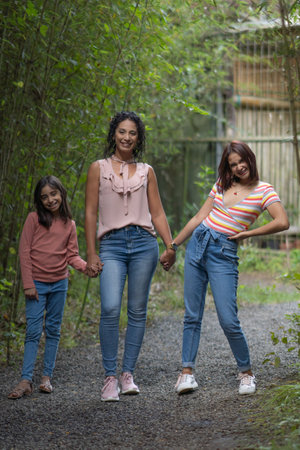 Beatiful mother and daughters enjoying a vacation day in the parkの写真素材
