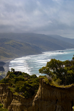 Cathedral Gully, clay cliffs in Canterbury New Zealand. View of the cliffs, with Gore Bay in the backgroundの写真素材