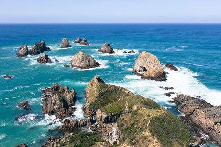 Rocks jutting out of the sea at Nugget Point, South Island, New Zealandの写真素材
