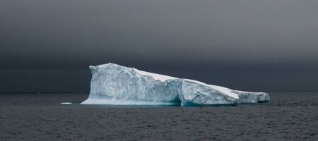 Antarctic iceberg in stormy weatherの写真素材