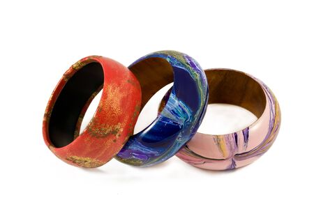 Closeup of three multicolored bangles isolated on a white backgroundの写真素材