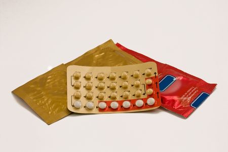 Male and female contraceptives: condom and the pill.の写真素材