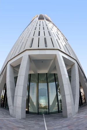 View of a skyscraper photographed with a fisheye lens, resulting in strong distortion and curvature of straight linesの写真素材
