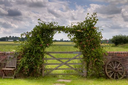 View of a field in Kent, England, viewed through a rustic old gate. HIgh dynamic range image.の写真素材