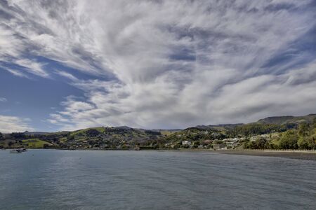 View of Akaroa Bay, New Zealand, with dramatic cloudscape.の写真素材