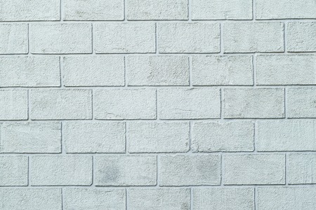 Photo texture of the plastered textured wall in the form of brick blocks of white color. Concrete block wallの写真素材