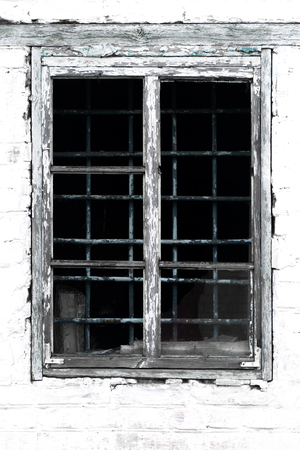 Texture of an old vintage window in a wooden frame against a white brick wall backgroundの写真素材