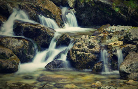 Nice detail of small cascade with mossy stones の写真素材
