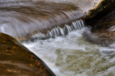 Detail of small cascade on mossy stone.