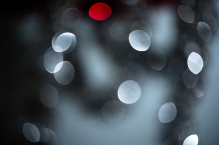 Red among silver circle blur lights, christmas background.の写真素材