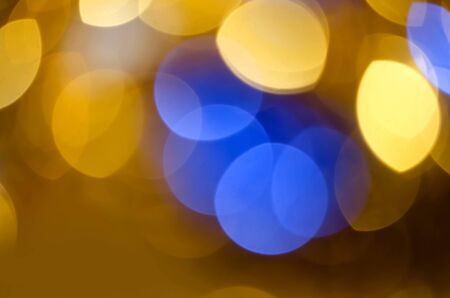 Gold blue blur circle lights as christmas colorful background.の写真素材