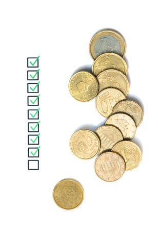 Questionnaire business concept and several euro coins.の写真素材