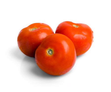 Three fresh dewy tomatoes isolated on white backgorund.の写真素材