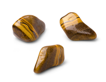 Tiger eye polished gem shot from three points of view isolated on white background.の写真素材