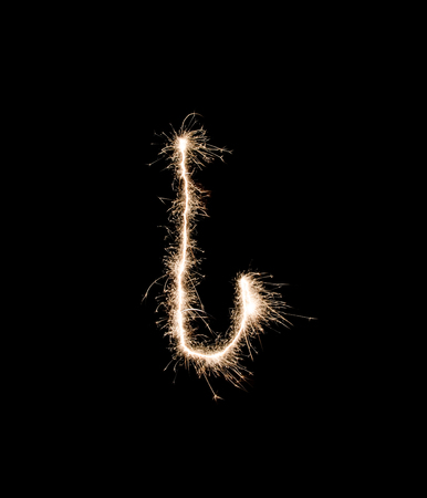 Letter I drew with spakrs on a black background.の写真素材