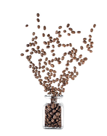 Glass jar of coffee beans isolated on white background.の写真素材