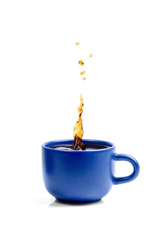 Blue porcelain cup isolated on white backgorund and fresh tasty splashing coffee.の写真素材
