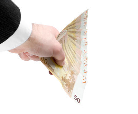 Businessman's hand holding a stack of fifty euro notes isolated on white background.の写真素材