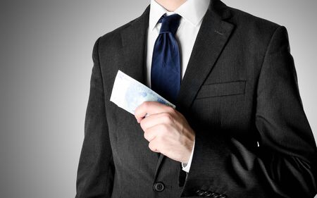 Businessman with blue tie holding twenty euro bank notes.の写真素材