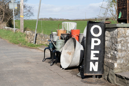 A view of a sign indicating an open shop with bric-a-brac on roadside display in the countryside.の写真素材