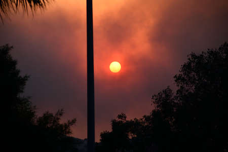 The Sun has a red hue due to the cloud of smoke caused by the Silverado Fire in Orange County, California, on October 26, 2020.の写真素材