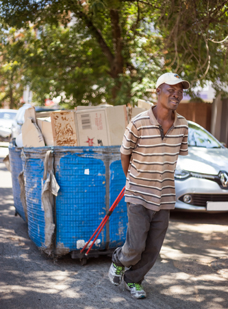 Johannesburg, Gauteng, South Africa, 2018/01/10. A Waste Picker in South Africa, pulling his waste collection basket to a central point. A recycling worker with a cart full of collected waste.のeditorial素材