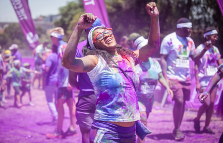 Runners at a colour run looking happy. Cape Town, South Africa - November 2, 2014.