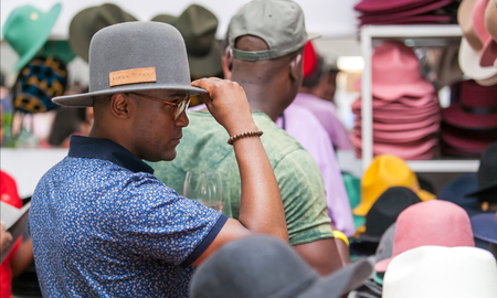 Man trying on a hat in a hat shop. Johannesburg, South Africa -October 16, 2016.のeditorial素材