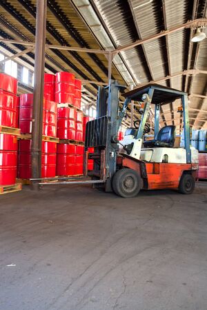 Johannesburg, South Africa, March 25 - 2015: Fork lift truck in a warehouse full of barrels.のeditorial素材