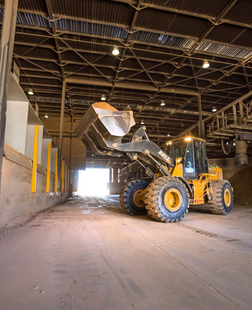 Cape Town, South Africa, June 29 - 2018: Digger truck loading clay in a ceramic tile manufacturing...