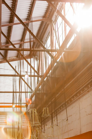 Light streaming through window in old factory with lens flares.