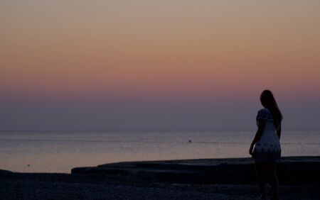 beautiful woman is watching the sunriseの写真素材