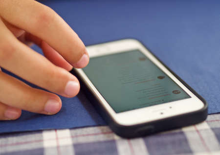 a young woman is using her mobile phoneの写真素材