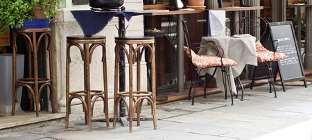 wooden tables and chairs in a restaurantの写真素材