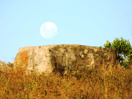 African Moon Rising over rock slab, South Africa.の写真素材