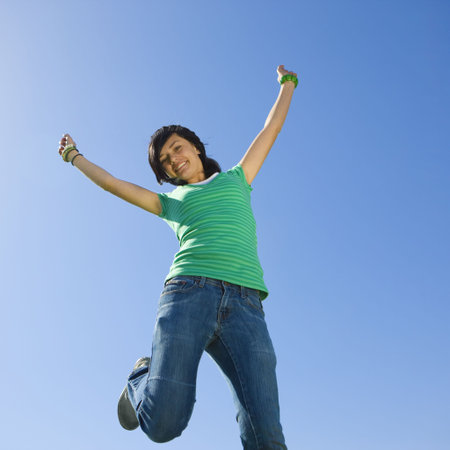 Happy teen jumps in air