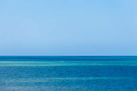 Shot of a birght blue sea and clear sky. Could be somewhere exoticの写真素材