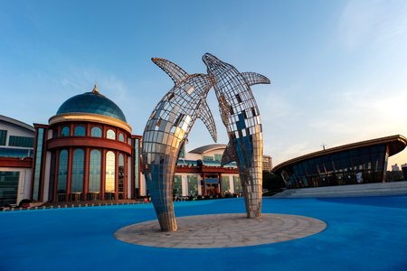 Stainless steel dolphin sculpture by the sea in Yantai, Chinaのeditorial素材