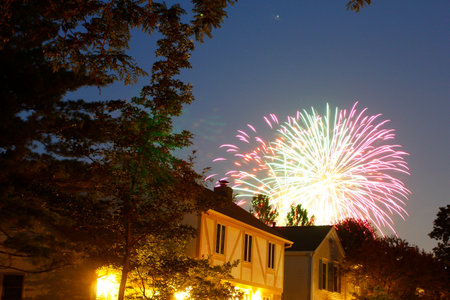 Fireworks Seen Over Houses in a Neighborhoodの写真素材