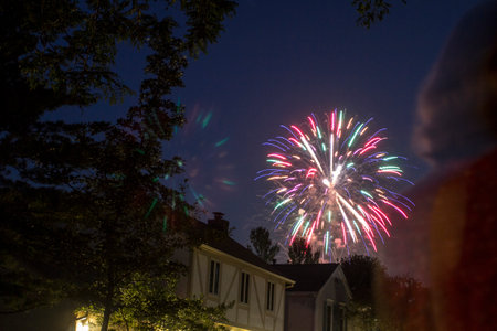 Fireworks Seen Over Houses in a Neighborhoodの写真素材